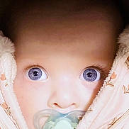 Ellie-Joy joined the competition — help win amazing prizes! baby, close_up, blue_eyes, pacifier, blanket, face, infant, child, snug, soft_texture, cute, wrapped, portrait, looking, young, cozy, warm, skin, expression, adorable