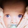 baby, close_up, blue_eyes, pacifier, blanket, face, infant, child, snug, soft_texture, cute, wrapped, portrait, looking, young, cozy, warm, skin, expression, adorable