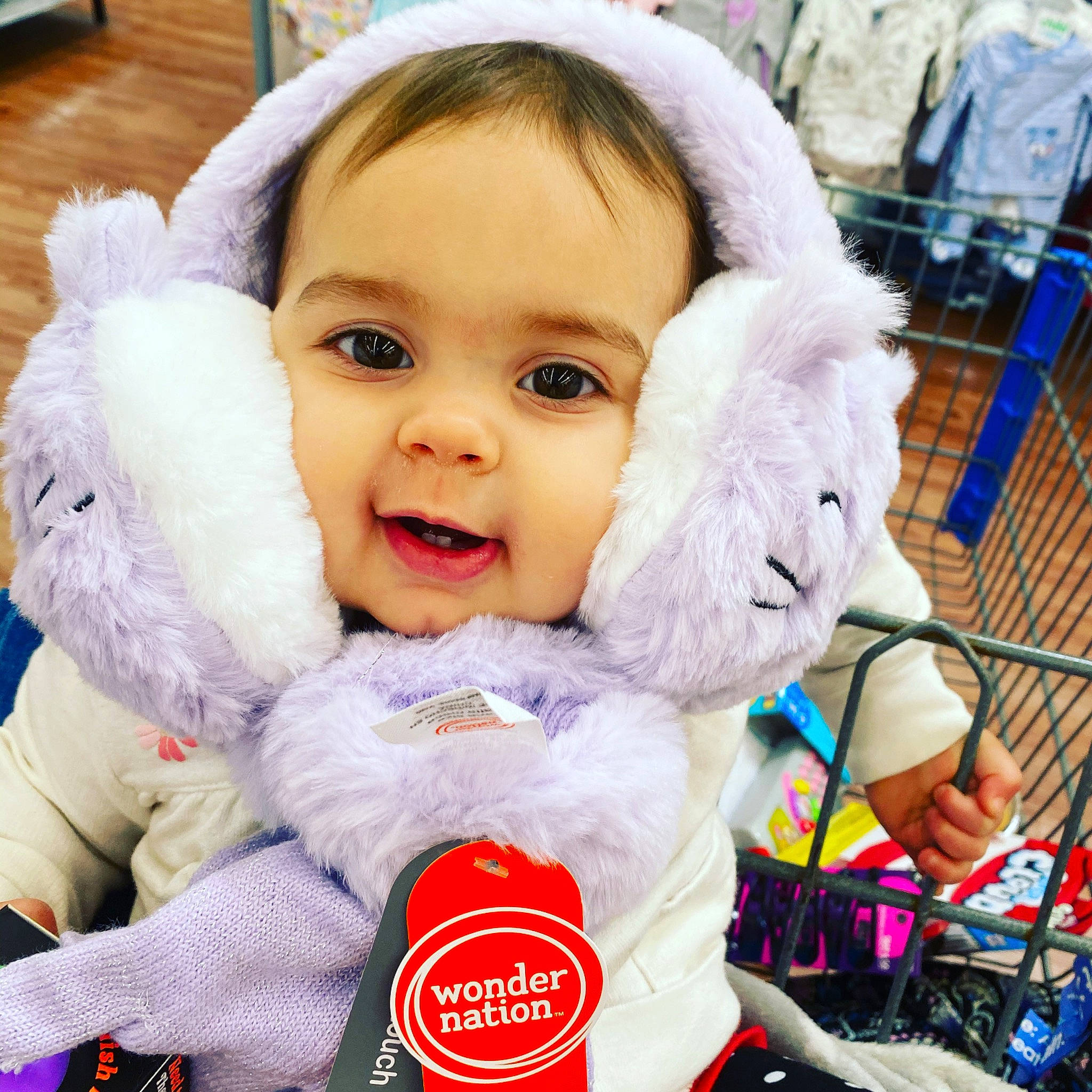 Madalynn is registered to the contest to win money with this photo: baby, baby_products, baby_toddler_clothing, baby_toys, basket, cabinetry, fur, glove, laminate_flooring, person, pleased, plush, puppet, stuffed_toy, textile, toy, wood_flooring