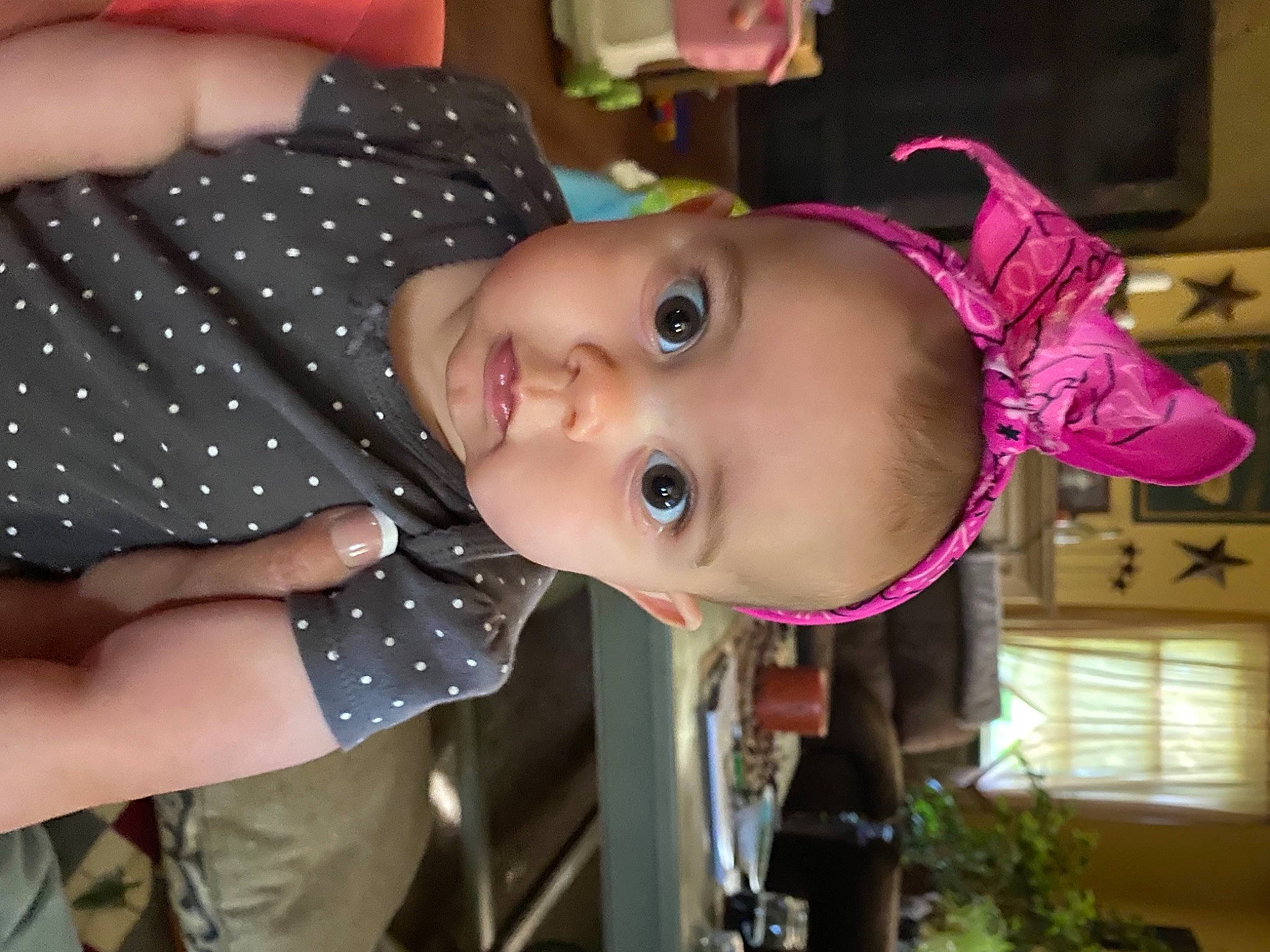 Madalynn is registered to the contest to win money with this photo: baby, baby_toddler_clothing, cheek, eye, eyelash, finger, houseplant, lip, mouth, nail, pattern, person, pink, polka_dot, throat, thumb, toddler, window_blind, wrist