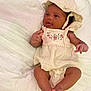 Kamora is registered to the contest to win money with this photo: baby, infant, child, hat, clothing, embroidery, cute, soft, white_background, relaxing, skin, foot, hand, portrait, smiling, indoors, laying, comfortable, newborn, apparel