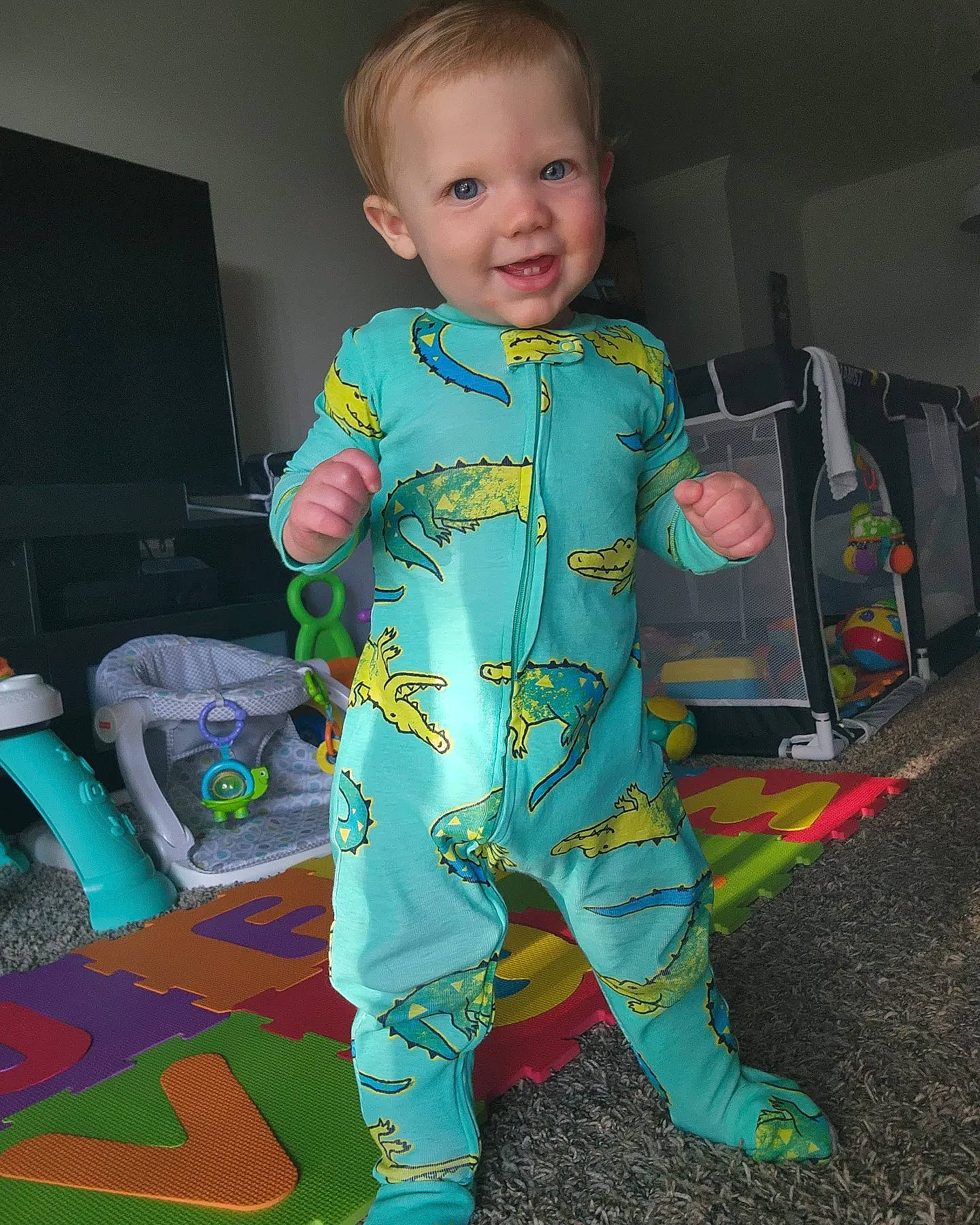 Richard Anthony is registered to the contest to win money with this photo: baby, baby_toddler_clothing, child, electric_blue, floor, flooring, fun, human_leg, joint, joy, nightwear, pajamas, pattern, person, play, room, sitting, sleeve, smile, t_shirt