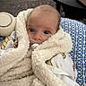 Ryder joined the competition — help win amazing prizes! baby, blanket, pacifier, infant, face, eyes, cushion, pattern, fabric, soft, home_interior, wood_floor, table, comfort, cute, wrapped, sleepy, child, newborn, portrait