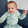 Alessio participe au concours pour gagner de l'argent avec cette photo : baby, child, infant, smiling, happy, blue_eyes, red_hair, tracksuit, sitting, couch, indoor, portrait, cute, young_child, clothing, person, face, casual, comfortable, home