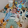 Kellyo a rejoint le concours — aidez-le/la à gagner de superbes lots ! baby, infant, stuffed_toys, plush, crib, blanket, clothing, blue, white, animal_toy, soft_toys, child, bed, cute, indoor, person, lying_down, smiling, mickey_mouse, rabbit_toy