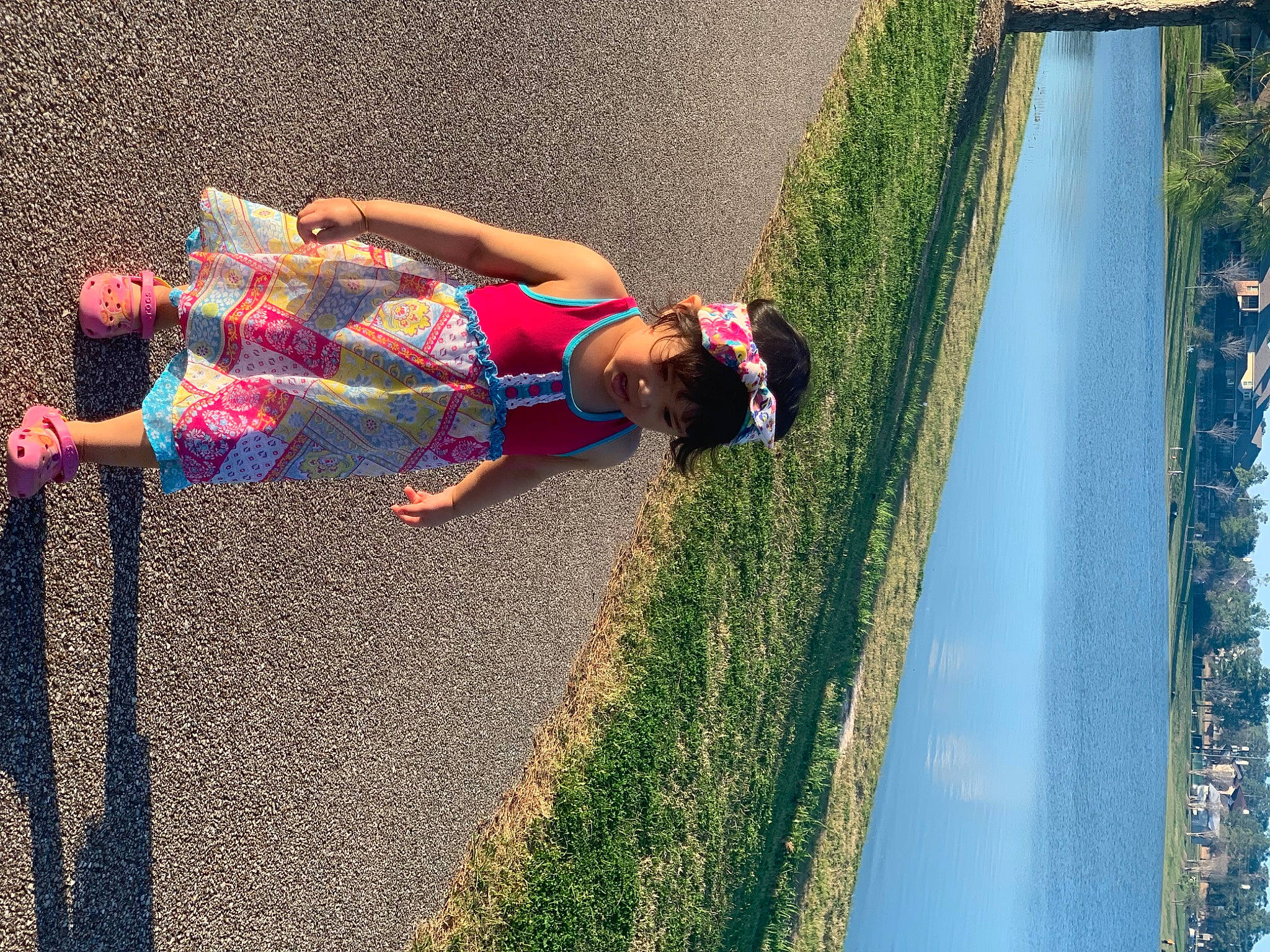 Amelia is registered to the contest to win money with this photo: asphalt, electric_blue, fun, grass, human_leg, knee, leisure, line, people_in_nature, person, plant, recreation, road, road_surface, sidewalk, sunlight, thigh, tints_and_shades, toddler, tree