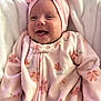 Kyla is registered to the contest to win money with this photo: baby, infant, smiling, pink_clothing, headband, onesie, blanket, happy, cute, child, soft_texture, indoor, portrait, newborn, cozy, warm, face, expression, sleepwear, baby_girl