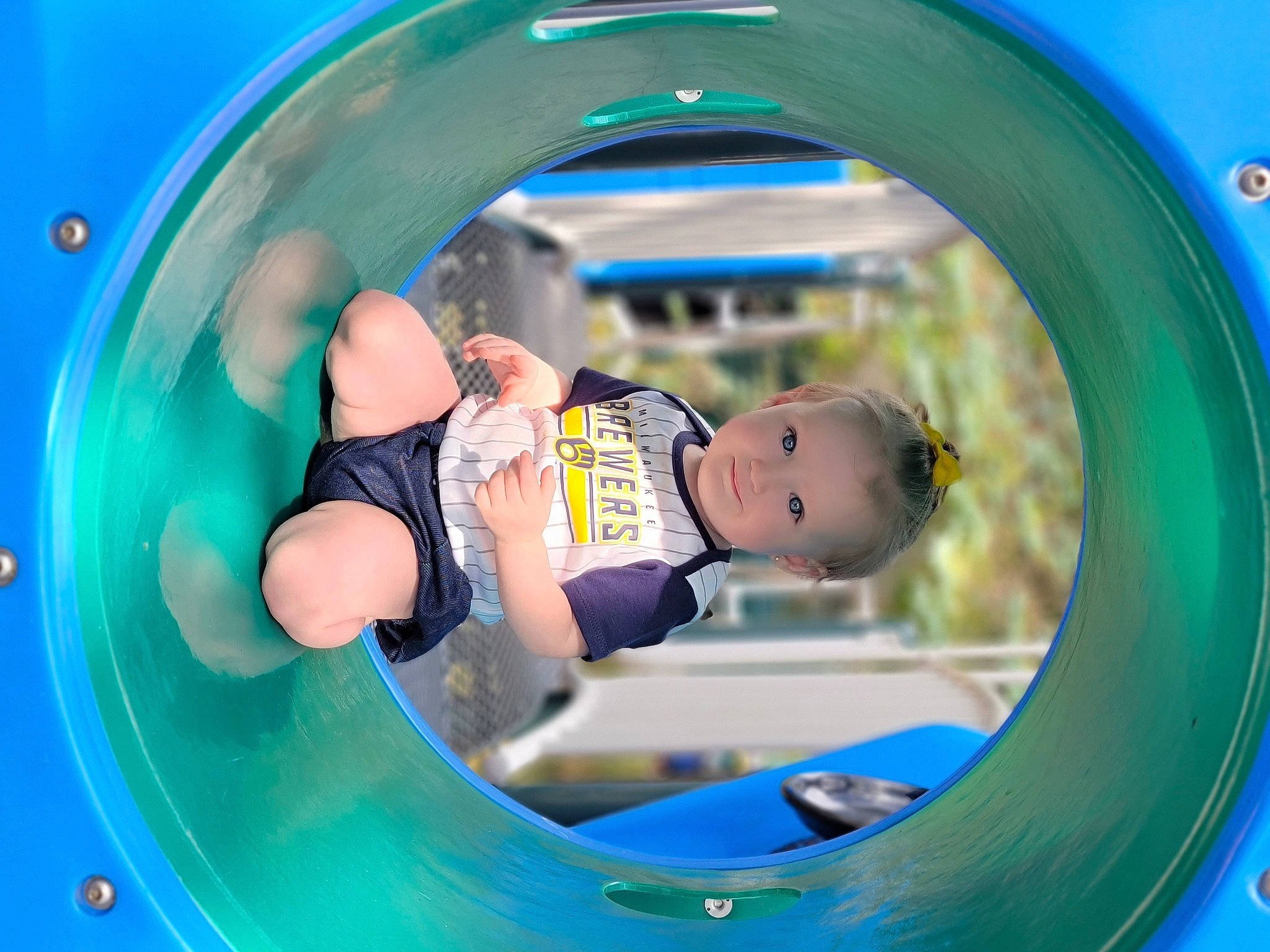 Ellianna joined the competition — help win amazing prizes! aqua, baby, baby_toddler_clothing, blue, child, chute, circle, electric_blue, facial_expression, fun, green, happy, leisure, outdoor_play_equipment, outdoor_recreation, person, play, playground, recreation, snapshot