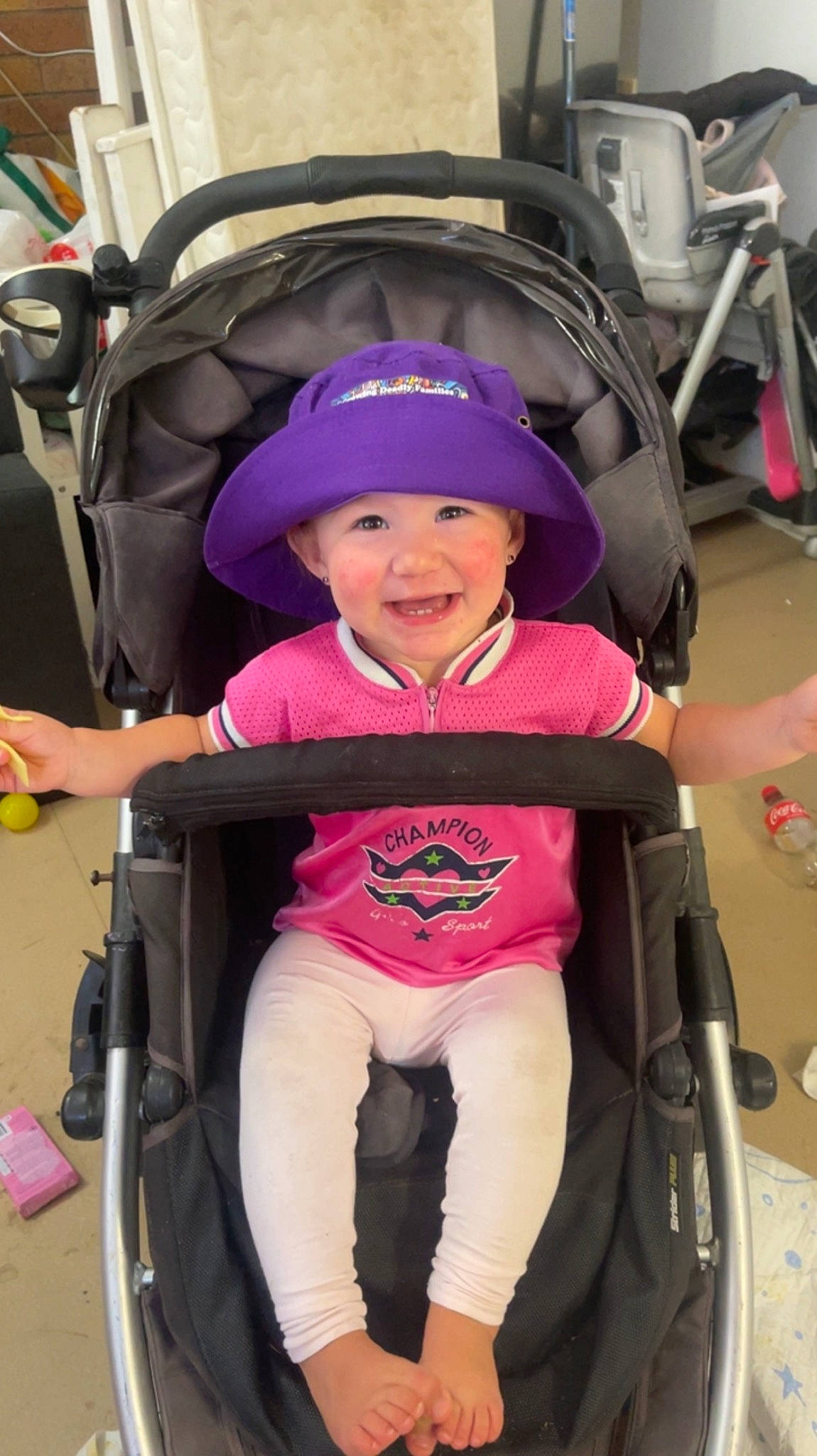 Penelope is registered to the contest to win money with this photo: auto_part, baby, baby_carriage, baby_products, baby_safety, baby_toddler_clothing, black, child, comfort, electric_blue, fun, headwear, joy, lap, magenta, person, product, purple, service, smile
