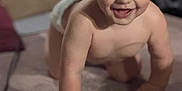 Xayden joined the competition — help win amazing prizes! baby, toddler, crawling, smiling, indoor, carpet, child, happy, face, skin, hair, hand, floor, plastic_bottle, diaper, cute, young_child, expression, person, playful