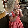 Laylani joined the competition — help win amazing prizes! toddler, child, hat, dress, indoor, living_room, couch, pout, cute, person, footwear, floor, kitchen, appliance, cabinet, table, expression, young_child, clothing, home