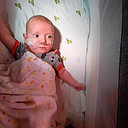 Milo joined the competition — help win amazing prizes! baby, crib, blanket, nasal_cannula, infant, mesh_side, sheet, pattern, clothing, bed, lying_down, child, medical, hospital, health, person, sleeping_area, toddler, resting, indoor