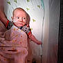 baby, crib, blanket, nasal_cannula, infant, mesh_side, sheet, pattern, clothing, bed, lying_down, child, medical, hospital, health, person, sleeping_area, toddler, resting, indoor
