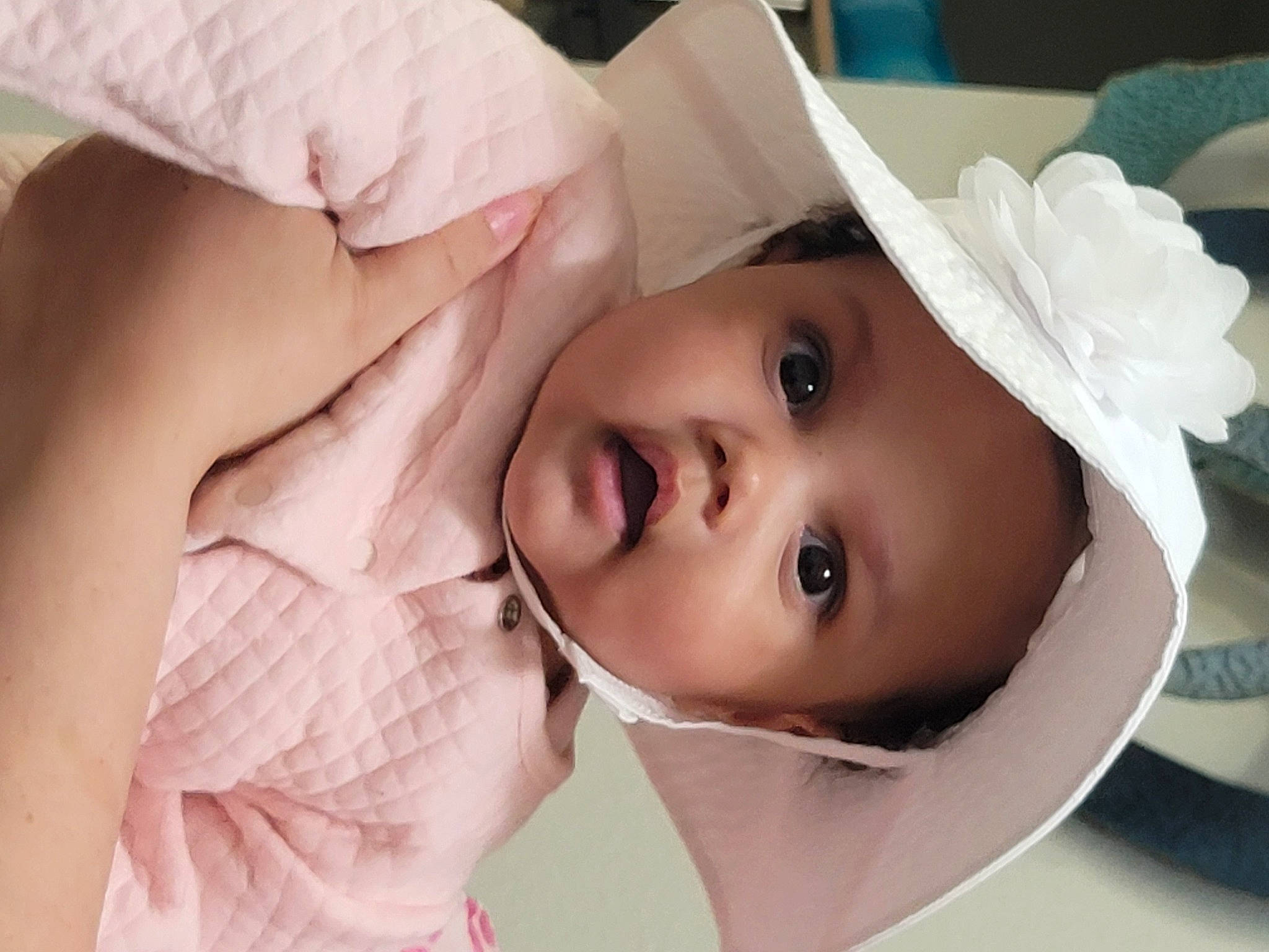 Evelyn is registered to the contest to win money with this photo: baby, bridal_accessory, child, dress, event, eye, eyebrow, eyelash, flash_photography, gesture, happy, hat, head, headpiece, headwear, iris, lip, nose, person, skin