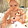 baby, bath, bathroom, bow, bubble_bath, child, chubby, cute, face, flower_petals, hands, headband, indoors, milky_water, playful, portrait, relaxation, sitting, skin, water