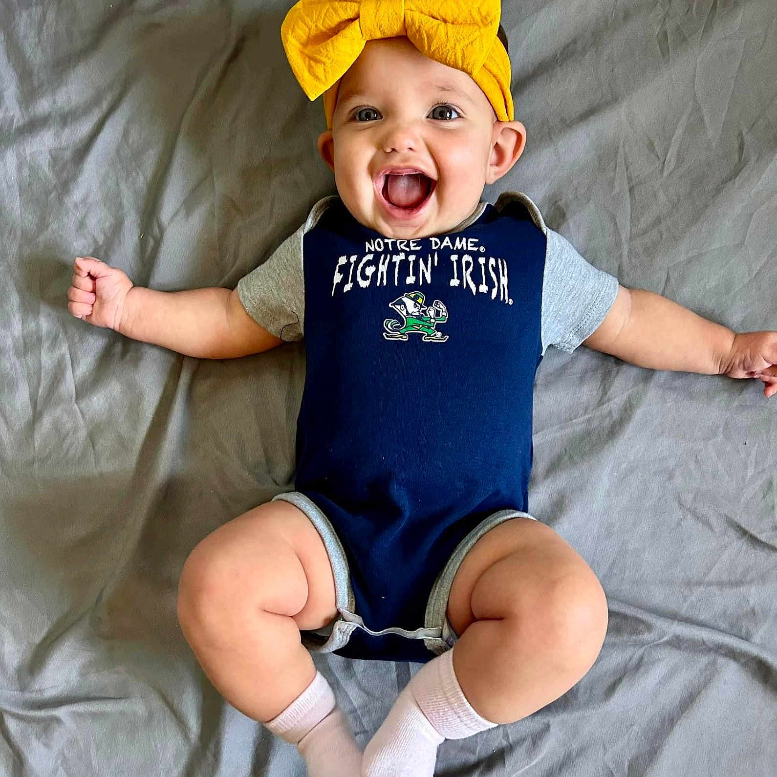 Eleanor joined the competition — help win amazing prizes! baby, babylaughing, cap, clothing, costume, face, happy, hat, head, hosiery, laughing, person, photography, portrait, sitting, smile, sock, yawning