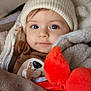 baby, blue_eyes, knitted_hat, plush_toy, blanket, jacket, pacifier, stroller, child, cute, infant, warm_clothing, soft_texture, portrait, face, smile, indoors, cozy, toddler, bundle
