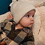 baby, child, hat, knit_hat, jacket, plaid, teddy_bear, stuffed_animal, blue_eyes, face, portrait, cozy, soft_texture, cute, indoor, looking_sideways, warm_clothing, infant, cuddly, comfort