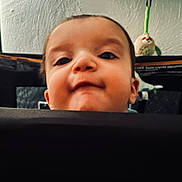 Ace is registered to the contest to win money with this photo: baby, child, face, peek, curious, close_up, toy, owl_toy, indoor, playful, infant, head, expression, background, person, young, cute, portrait, looking_up, smile