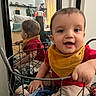 Ace joined the competition — help win amazing prizes! baby, child, smiling, indoor, mirror, reflection, wire_basket, clothing, yellow_bib, red_shirt, beige_pants, happy, sitting, furniture, curtain, home, portrait, closeup, cozy, person