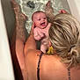 Harlow joined the competition — help win amazing prizes! baby, bathtub, water, adult, blonde_hair, tattoo, toy, orange_toy, smiling, happy, skin, splash, bath_time, parent, child, holding, wet, fun, indoor, relaxing