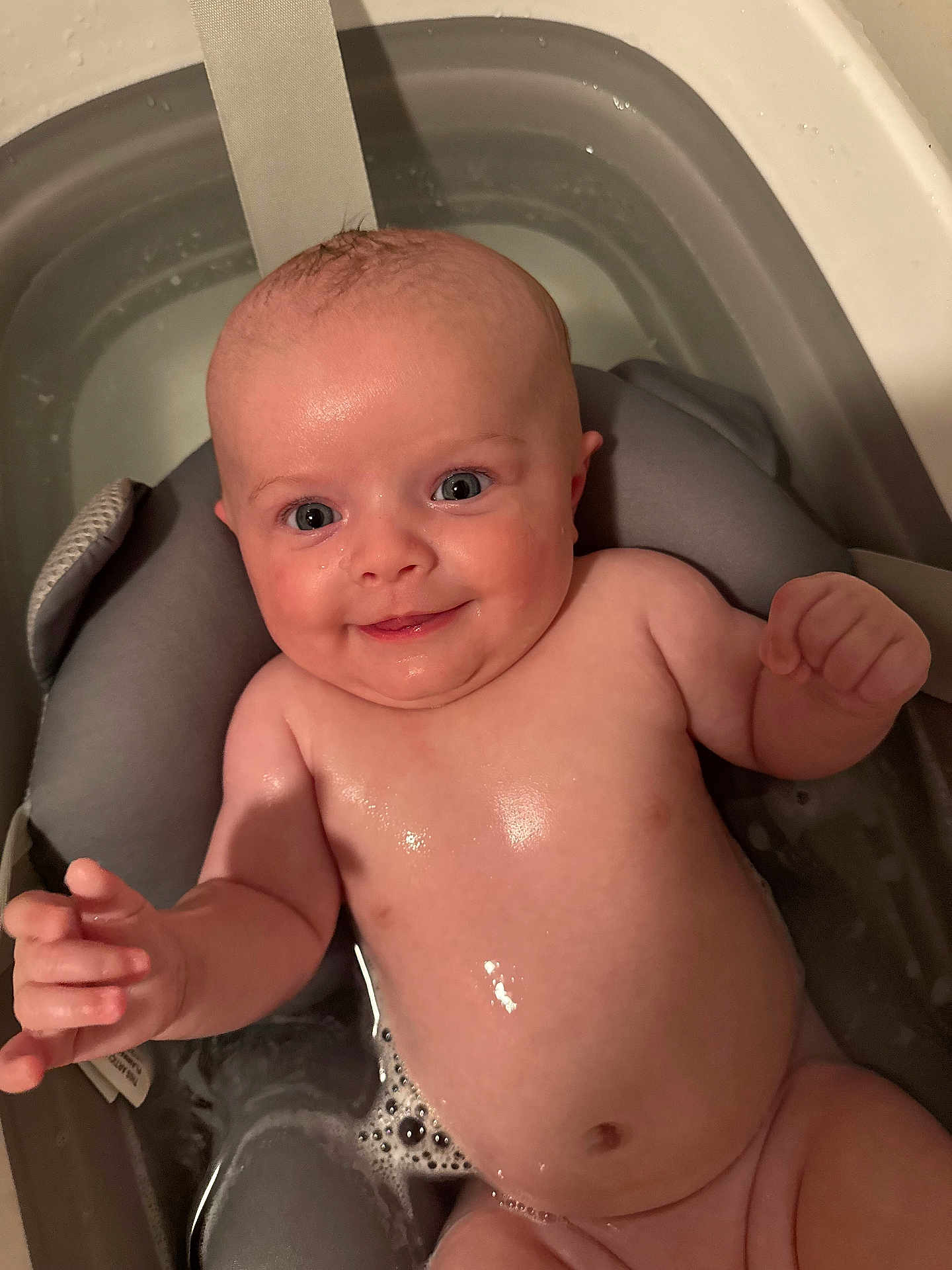 Harlow is registered to the contest to win money with this photo: baby, bath, water, smile, happy, child, skin, face, chubby, cute, infant, tub, bubble, sitting, naked, bath_time, support, indoors, cute_baby, joy