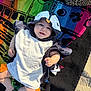 Gabin participe au concours pour gagner de l'argent avec cette photo : baby, child, penguin_costume, towel, beach_towel, colorful, smiling, happy, outdoor, sunlight, infant, cute, playful, barefoot, summer, relaxing, person, portrait, clothing, fun