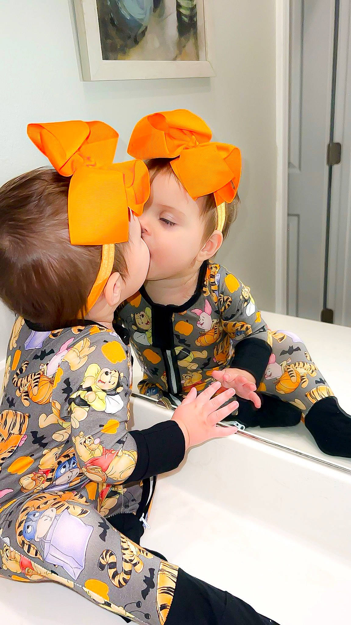 Oakleigh is registered to the contest to win money with this photo: baby, baby_toddler_clothing, baseball_cap, cap, child, door, facial_expression, fun, hairstyle, happy, hat, outerwear, person, play, room, sitting, sleeve, smile, t_shirt, table