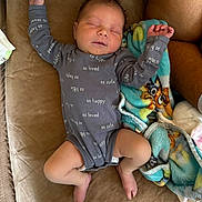 Taytum is registered to the contest to win money with this photo: baby, infant, sleeping, onesie, blanket, couch, cozy, child, cute, peaceful, indoors, soft, clothing, person, relaxing, comfort, small, happy, toddler, home