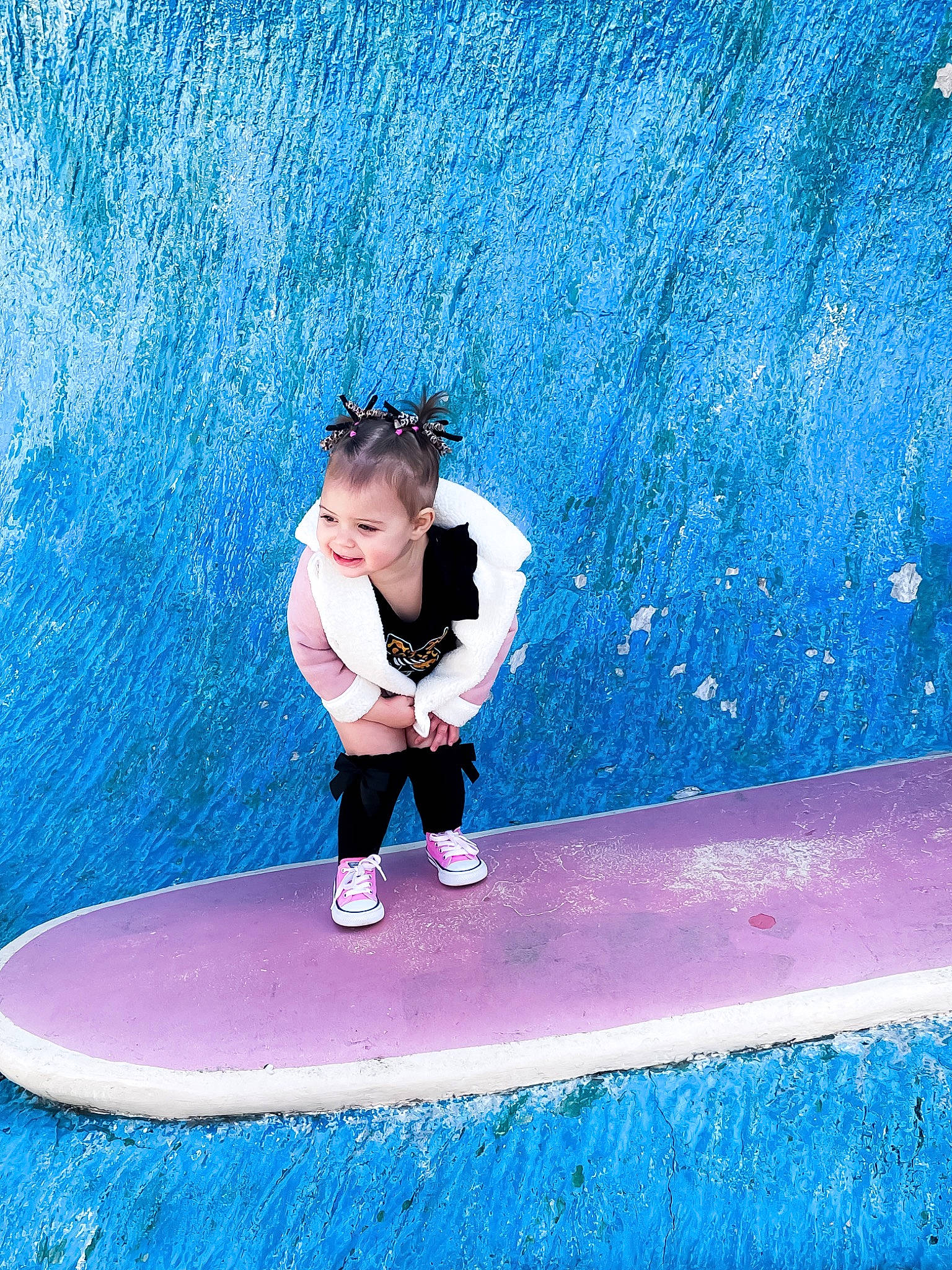 Oakleigh is registered to the contest to win money with this photo: azure, balance, blue, electric_blue, flash_photography, fun, happy, human_body, joy, knee, leg, leisure, magenta, people_in_nature, person, pink, recreation, sports, surfboard, surfing