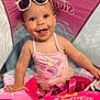 baby, child, curly_hair, cute, face, float, fun, happy, indoors, person, pink, playful, smiling, summer, sunglasses, swimbobs, swimsuit, toddler, unicorn, water_toy
