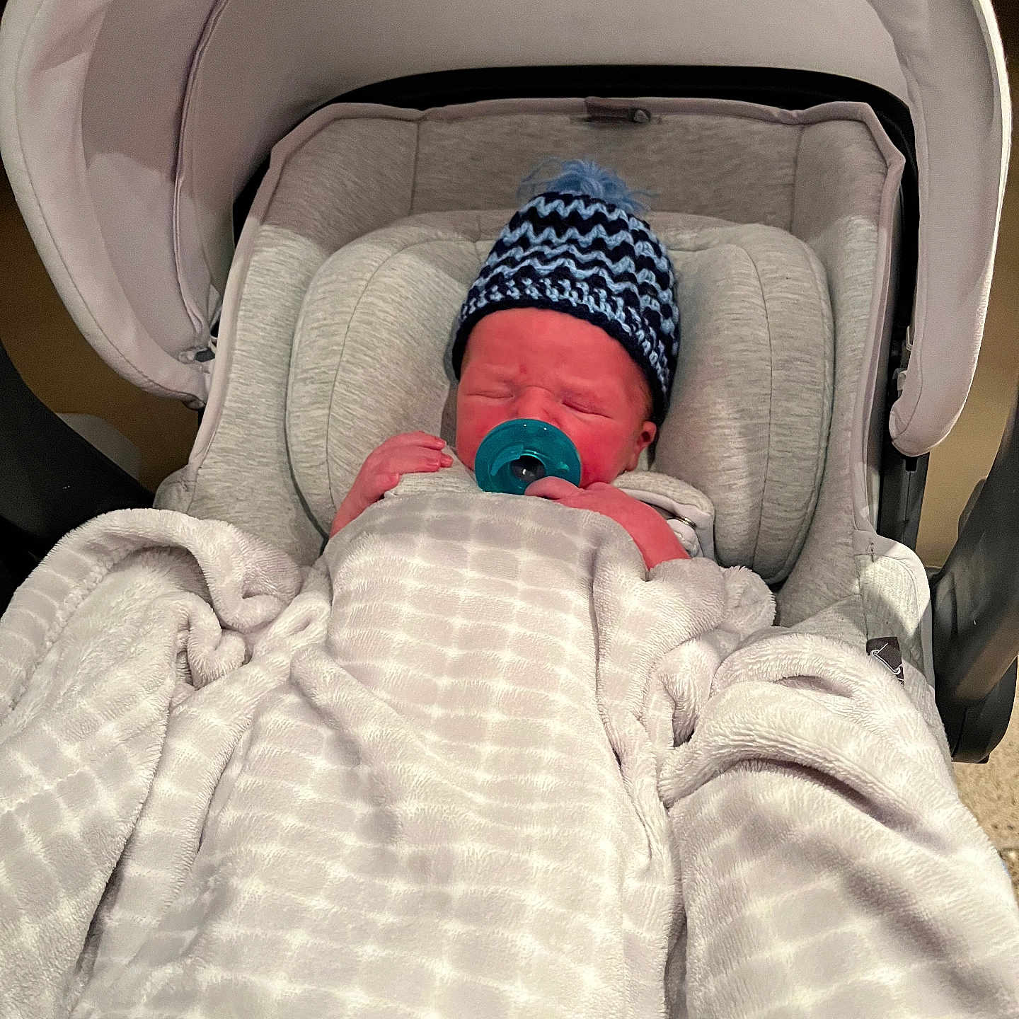 Rylan joined the competition — help win amazing prizes! baby, blanket, bundle, car_seat, child, comfort, cozy, cute, hat, headwear, indoors, infant, knitted, newborn, pacifier, portrait, resting, sleeping, soft, young