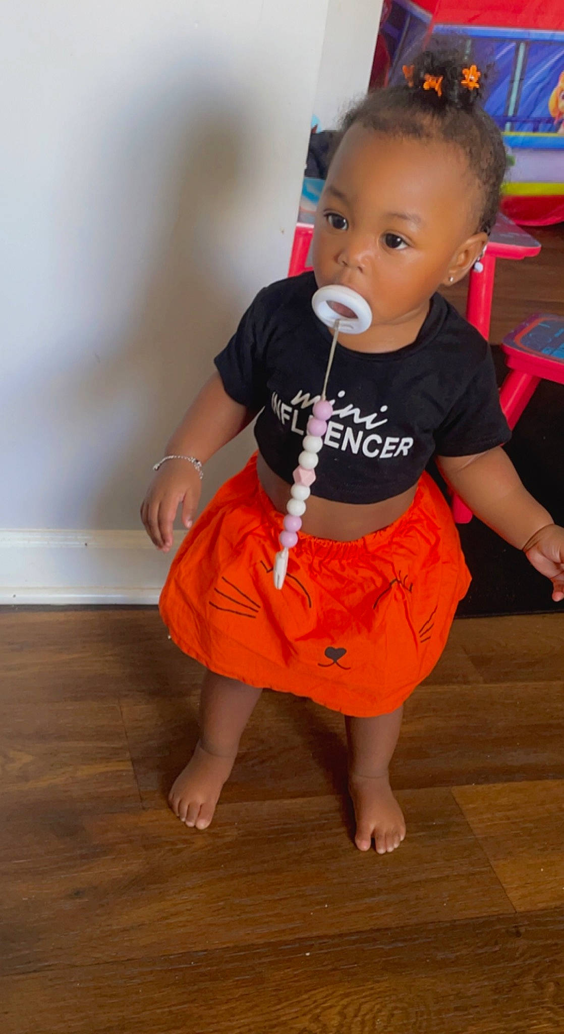 Lyric joined the competition — help win amazing prizes! baby, baby_toddler_clothing, barefoot, child, floor, flooring, foot, fun, happy, hardwood, human_leg, knee, leg, orange, person, sitting, sleeve, t_shirt, toddler, wood