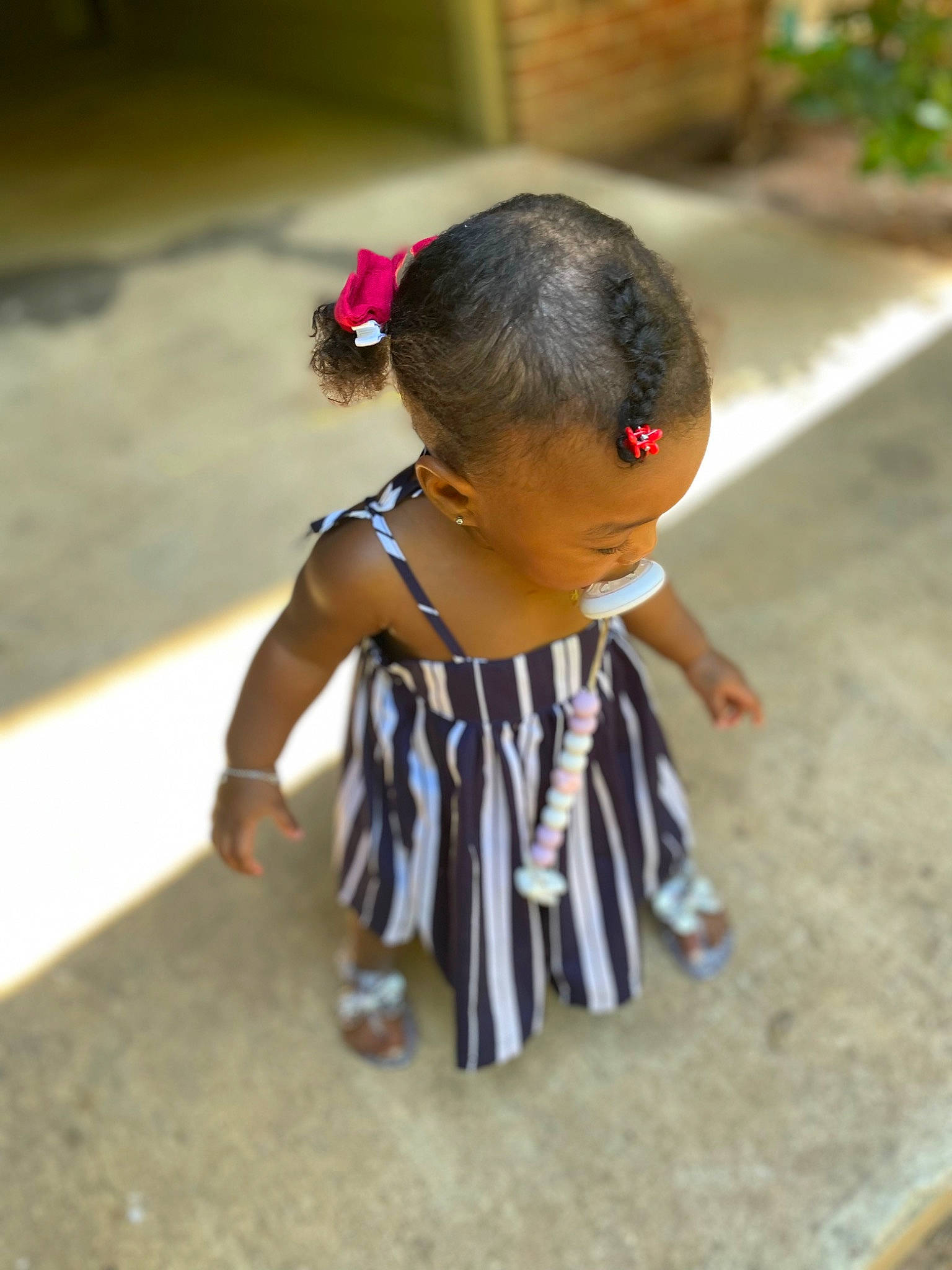 Lyric is registered to the contest to win money with this photo: bracelet, child, face, fashion_accessory, flooring, fun, grass, happy, jewellery, leisure, person, plant, sitting, soil, temple, toddler, tradition, tree, tribe, vacation