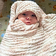 Gabriell joined the competition — help win amazing prizes! baby, blanket, wrapped, soft_texture, face, wide_eyes, infant, cozy, cute, expression, indoor, animal_pattern, nursery, child, portrait, warm, head, snug, newborn, curious