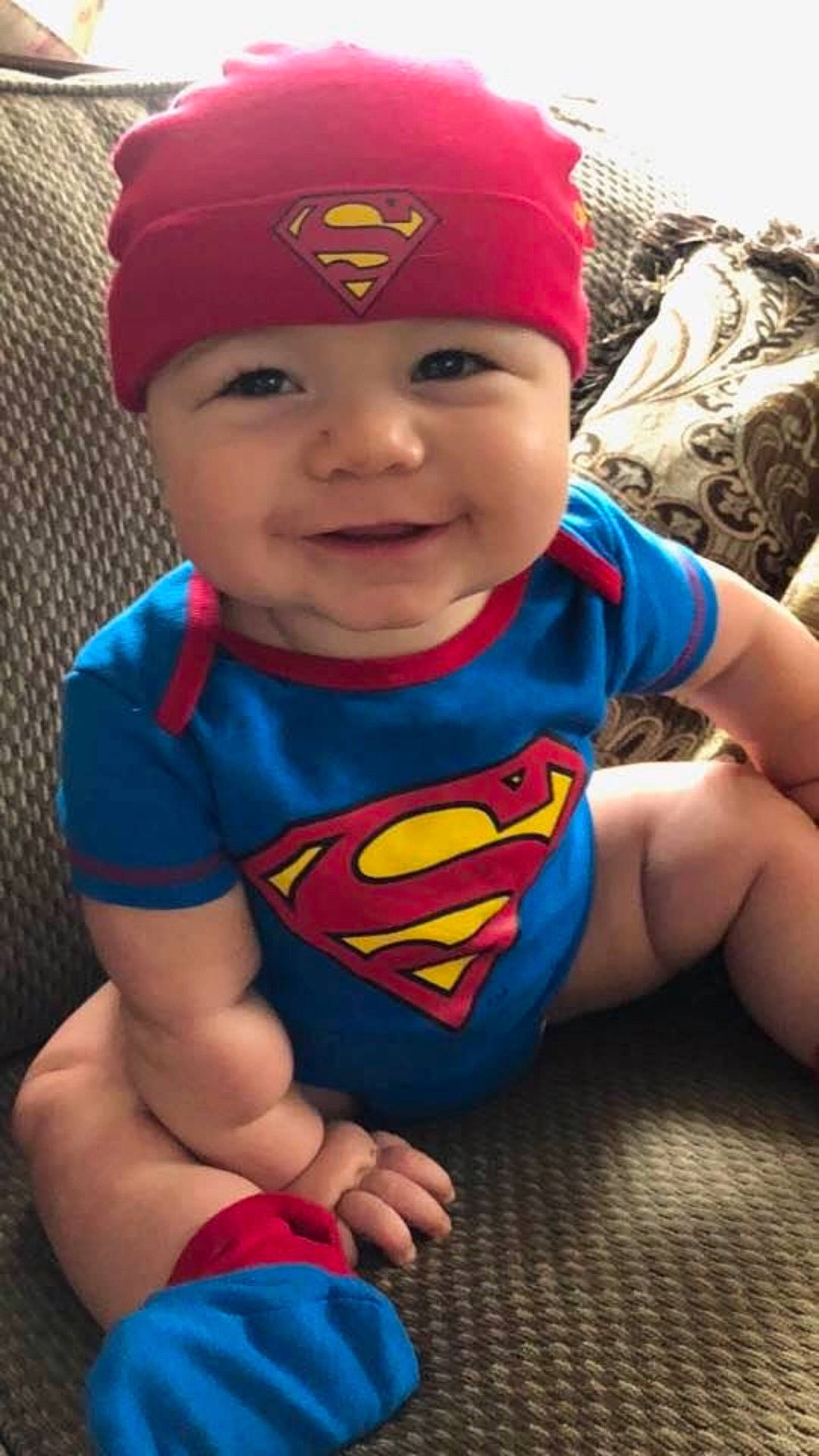 Jaxon Daniel is registered to the contest to win money with this photo: arm, blue, cap, child, cool, electric_blue, fun, hair_accessory, headgear, infant, person, product, red, smile, superhero, superman, textile, toddler