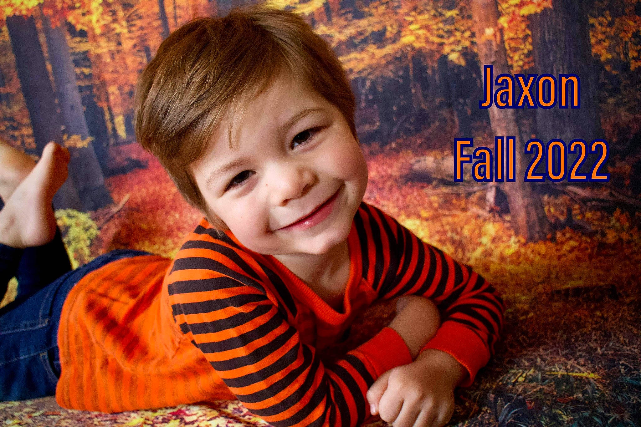 Jaxon joined the competition — help win amazing prizes! baby, child, facial_expression, flash_photography, fun, grass, happy, joy, leaf, leisure, orange, people, people_in_nature, person, plant, sitting, skin, smile, t_shirt, toddler