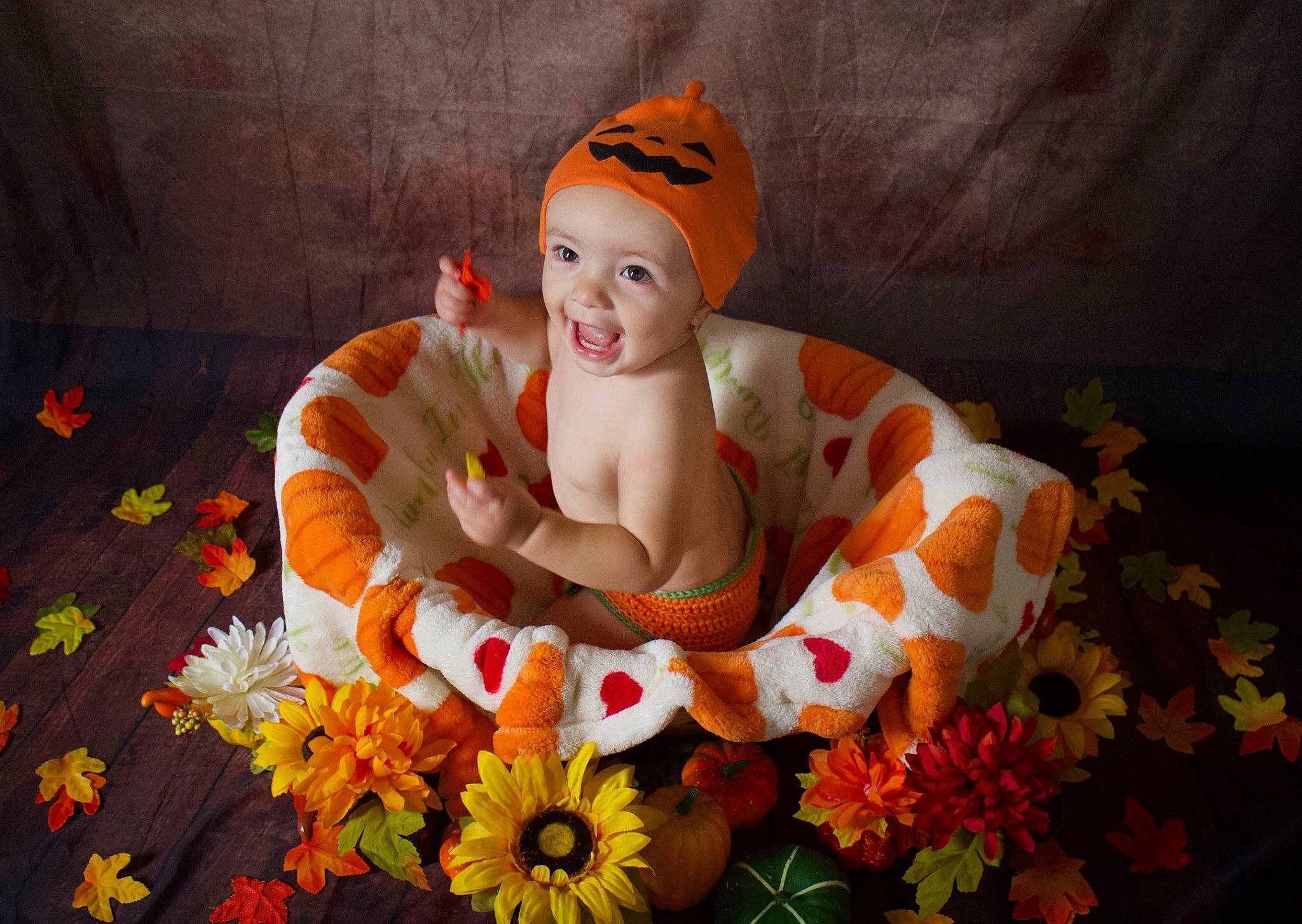 Luka is registered to the contest to win money with this photo: art, artificial_flower, baby, bouquet, child, cut_flowers, event, floral_design, floristry, flower, flower_arranging, flowering_plant, grass, happy, headwear, orange, person, petal, plant, smile