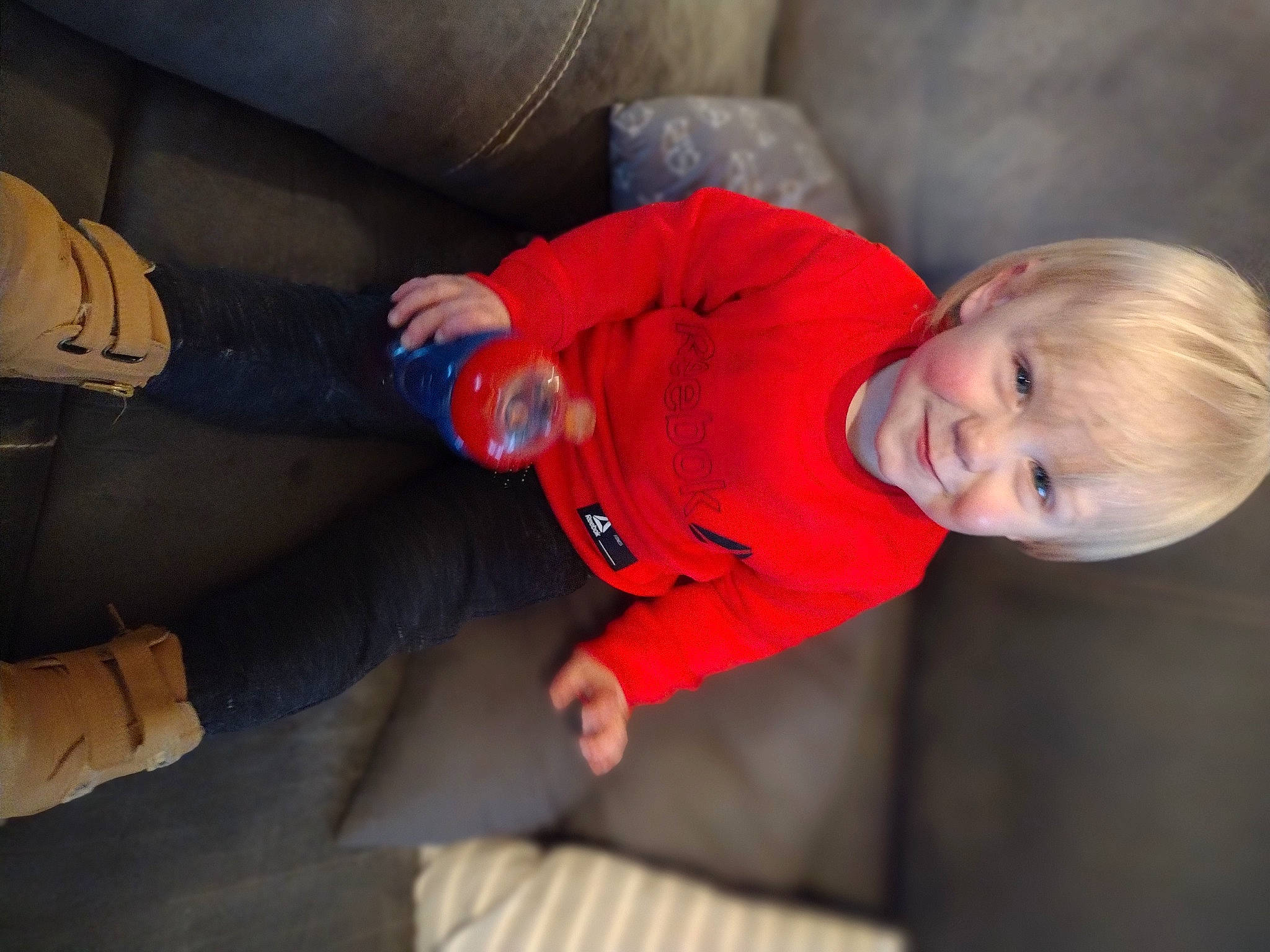 Max is registered to the contest to win money with this photo: arm, baby, baby_toddler_clothing, comfort, finger, fun, hand, human_body, joint, joy, knee, lap, leg, mammal, mouth, person, skin, sleeve, textile, thigh