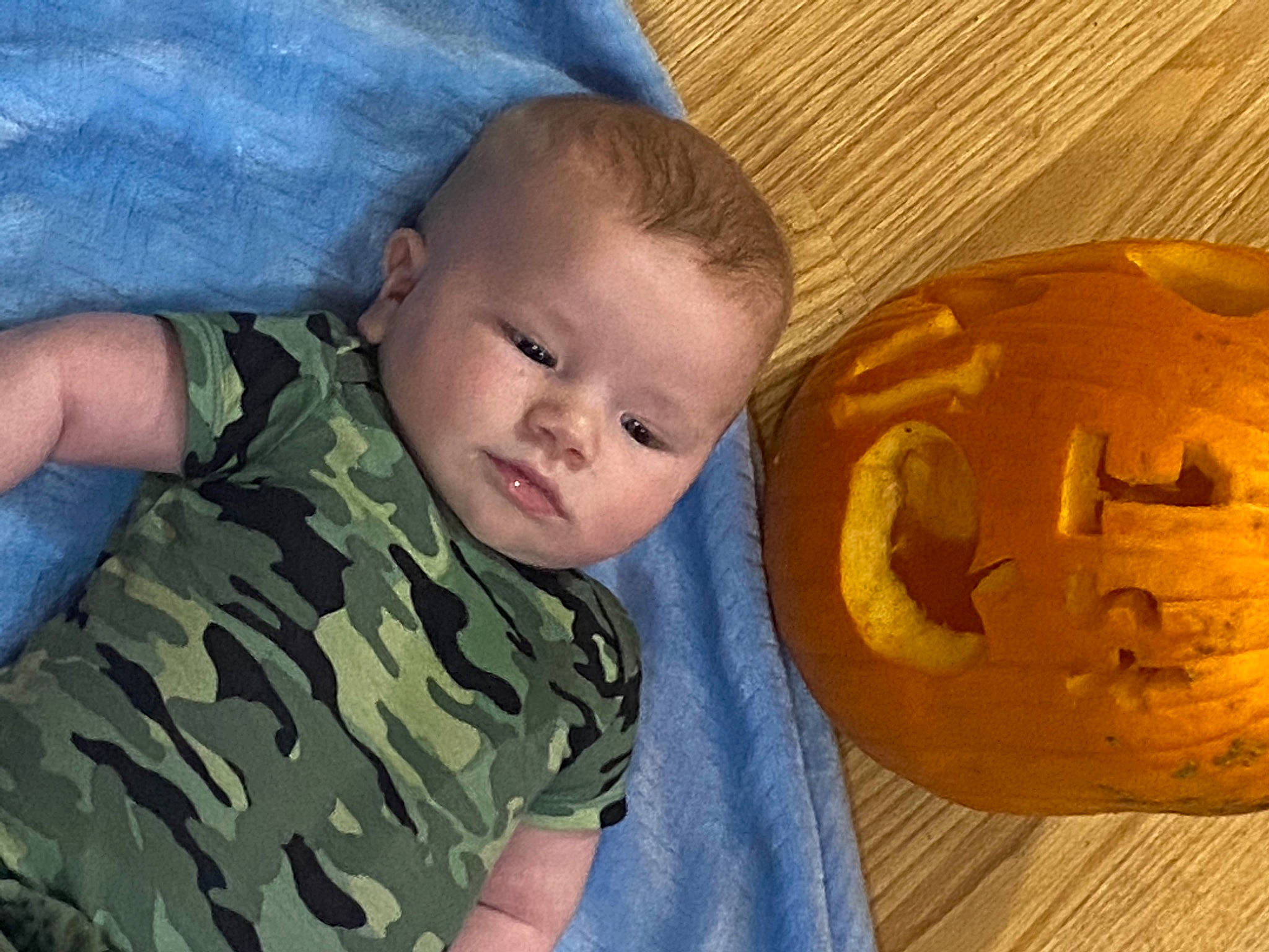 Aaron is registered to the contest to win money with this photo: arm, baby, calabaza, cheek, child, face, head, mouth, nose, person, play, pumpkin, toddler, winter_squash, world