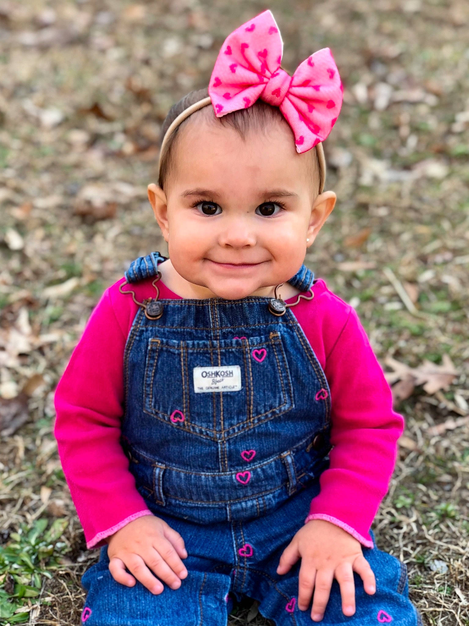 Lillia is registered to the contest to win money with this photo: baby, baby_toddler_clothing, cap, dress, eye, grass, happy, head, headgear, joy, magenta, pattern, people_in_nature, person, pink, plaid, plant, red, sleeve, smile