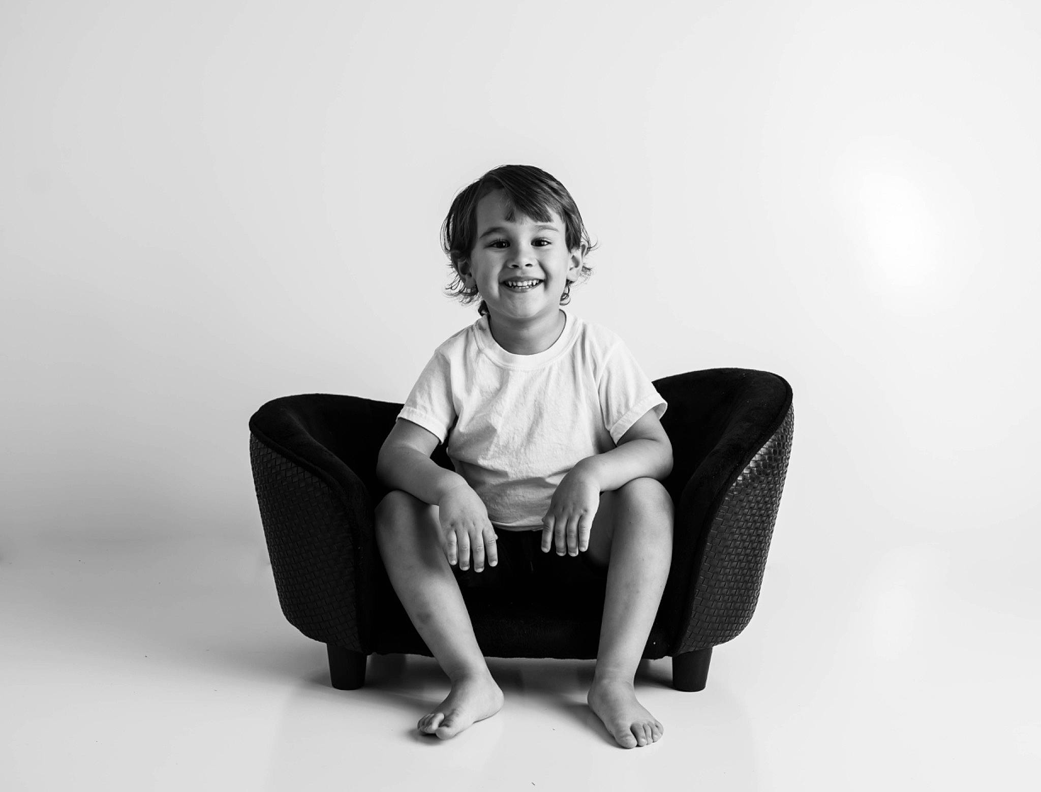 Sawyer is registered to the contest to win money with this photo: black, black_and_white, chair, comfort, furniture, joy, leg, monochrome, monochrome_photography, person, photo_shoot, photography, portrait, portrait_photography, sitting, smile, stock_photography, style, white