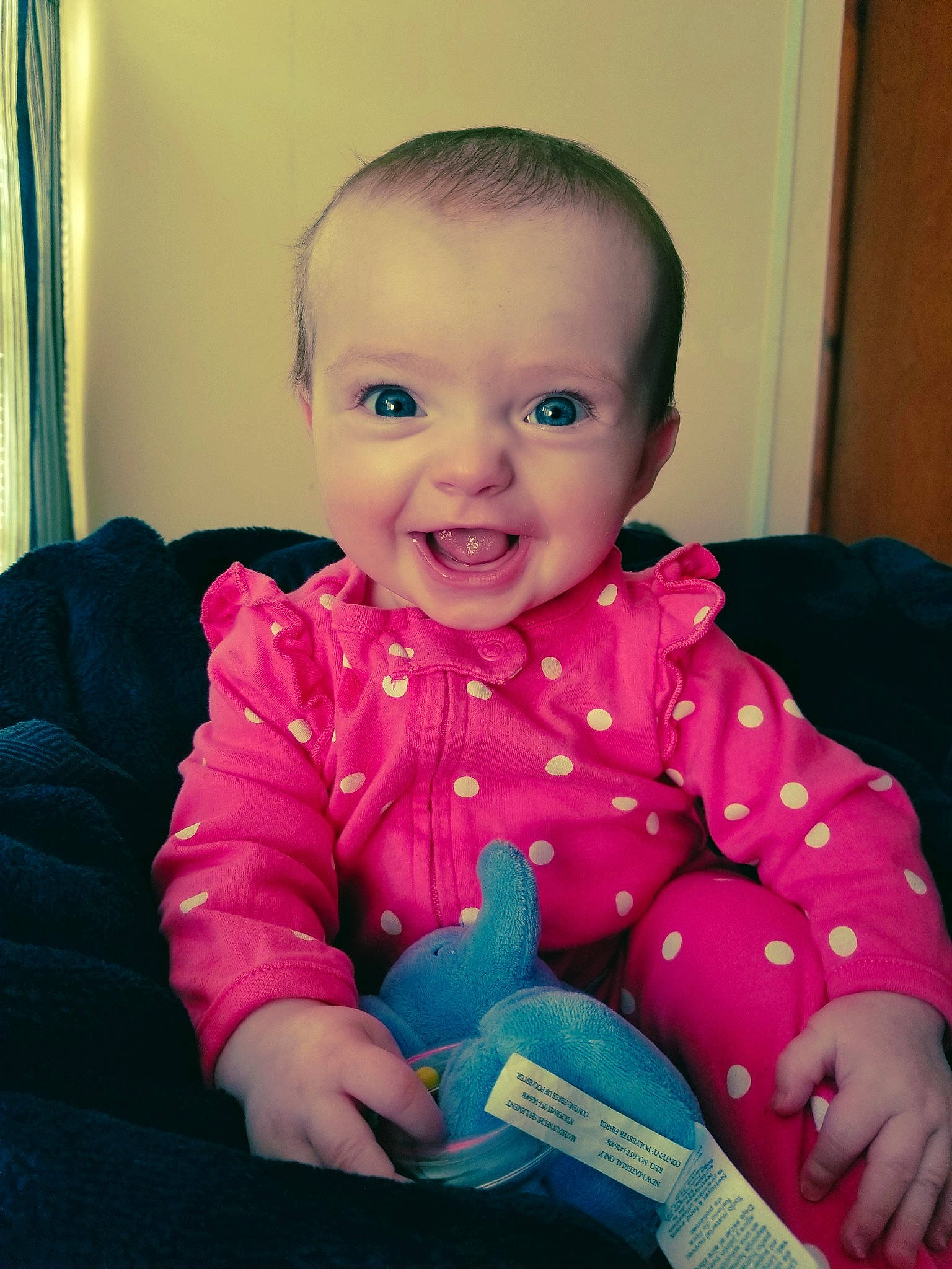 Gemma is registered to the contest to win money with this photo: baby, beauty, cheek, child, chin, eye, face, finger, head, iris, joy, lip, mouth, nose, person, pink, play, sitting, skin, smile