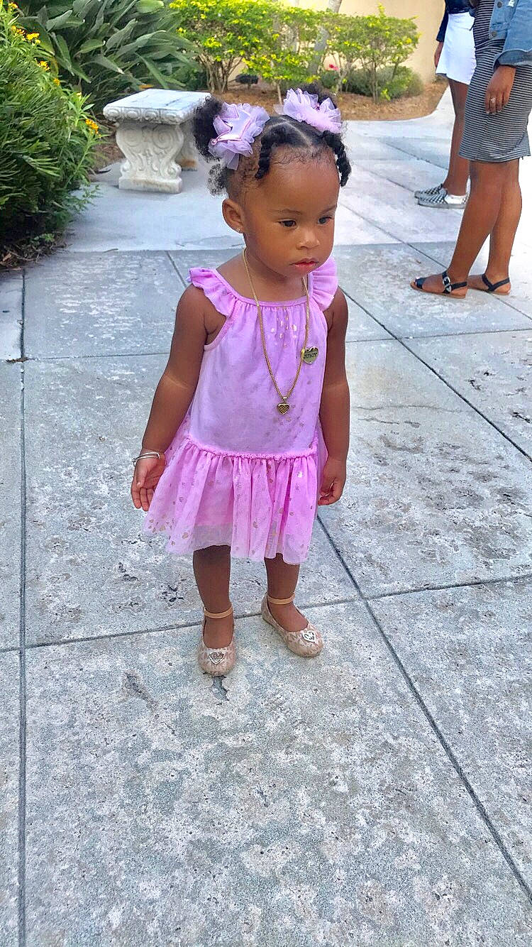 Kimora is registered to the contest to win money with this photo: child, dress, flower, person, pink, plant, smile, textile, toddler