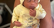 Jamina is registered to the contest to win money with this photo: baby, child, cozy, cute, footwear, hand, hat, indoor, infant, legs, newborn, pajamas, peaceful, person, portrait, resting, skin, sleeping, soft, yellow_clothing