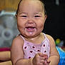 baby, child, smiling, happy, indoor, face, person, cute, pink_clothing, ladybug_pattern, chubby_cheeks, sitting, infant, joyful, closeup, skin, head, arms, hands, expression