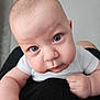 Kenan participe au concours pour gagner de l'argent avec cette photo : baby, infant, face, eyes, chubby_cheeks, skin, arm, hand, white_shirt, black_clothing, closeup, portrait, curious, cute, child, person, indoor, soft_light, head, expression