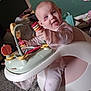 Bella joined the competition — help win amazing prizes! baby, child, infant, pink_clothing, toy, activity_seat, smiling, happy, indoor, carpet, face, hand, play, seat, furniture, person, cute, young_child, expression, colorful