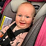 baby, child, car_seat, smile, happy, blue_eyes, safety_harness, pink, gray, clothing, infant, seatbelt, cute, portrait, indoors, person, young_child, sitting, face, expression