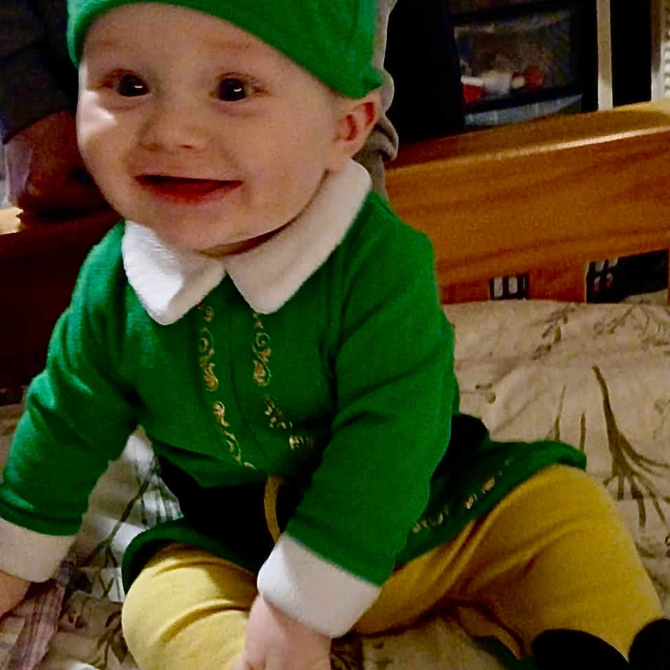 Chester is registered to the contest to win money with this photo: architecture, baby, building, cap, clothing, computerhardware, costume, couch, face, furniture, happy, hat, head, indoors, livingroom, pants, person, photography, portrait, room